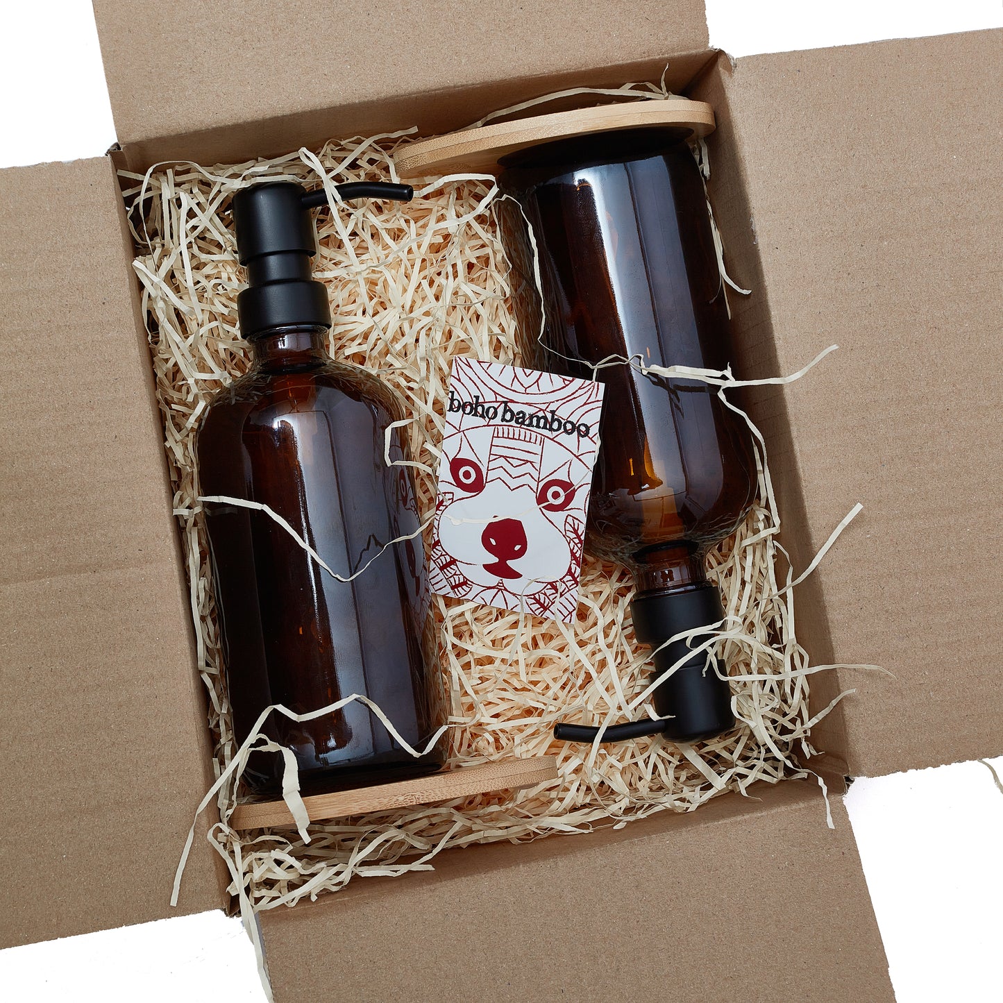 Set of two 500ml refillable amber glass pump bottles with bamboo drip trays